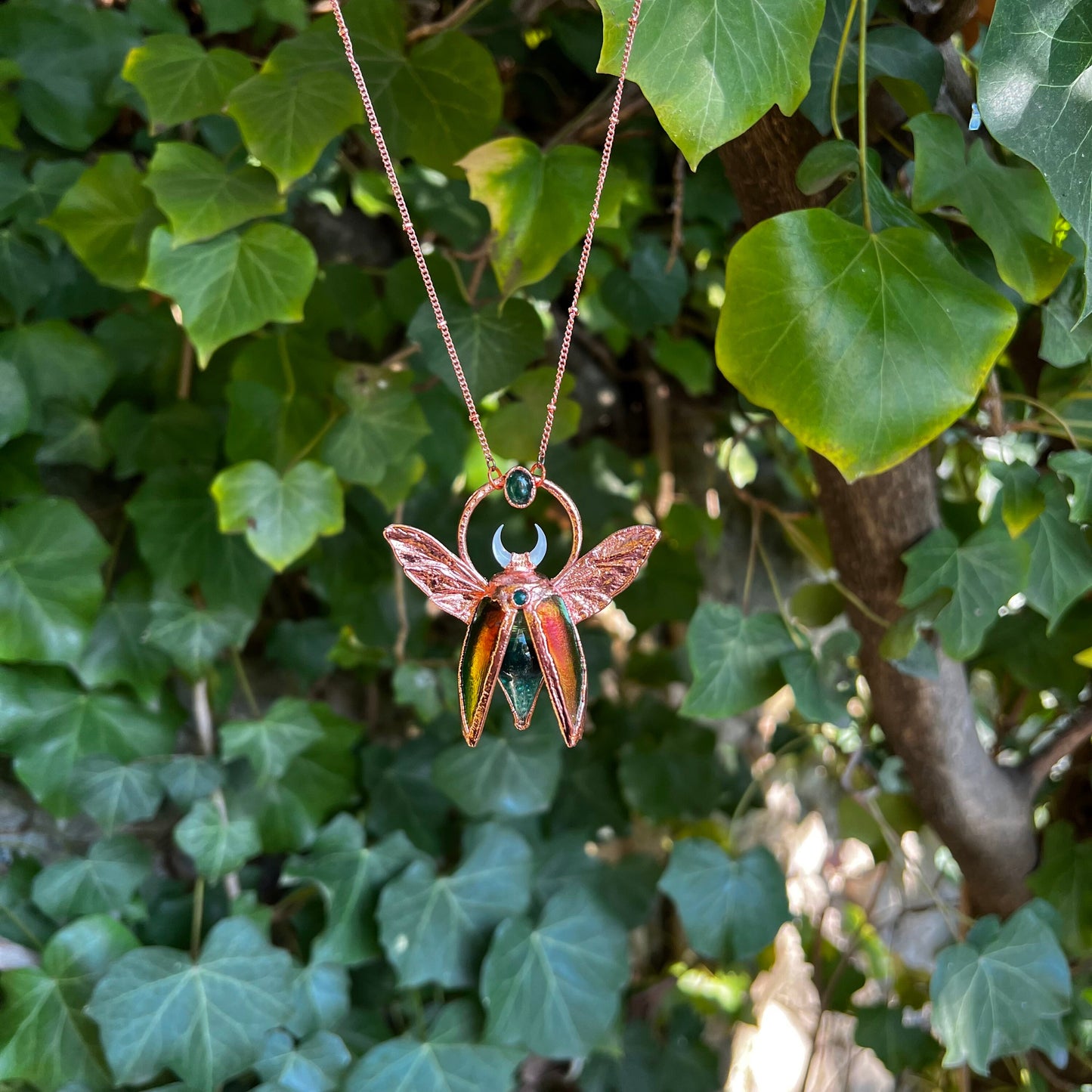 Chimera vial necklace with glittery green water, Copper eformed real beetle wings and elytras with two green onix and a seashell