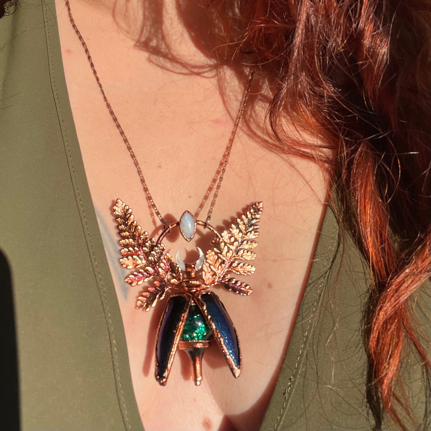 Chimera vial necklace with glittery green water, Copper eformed real beetle elytras with ferns wings, a rainbow moonstone and a white moon