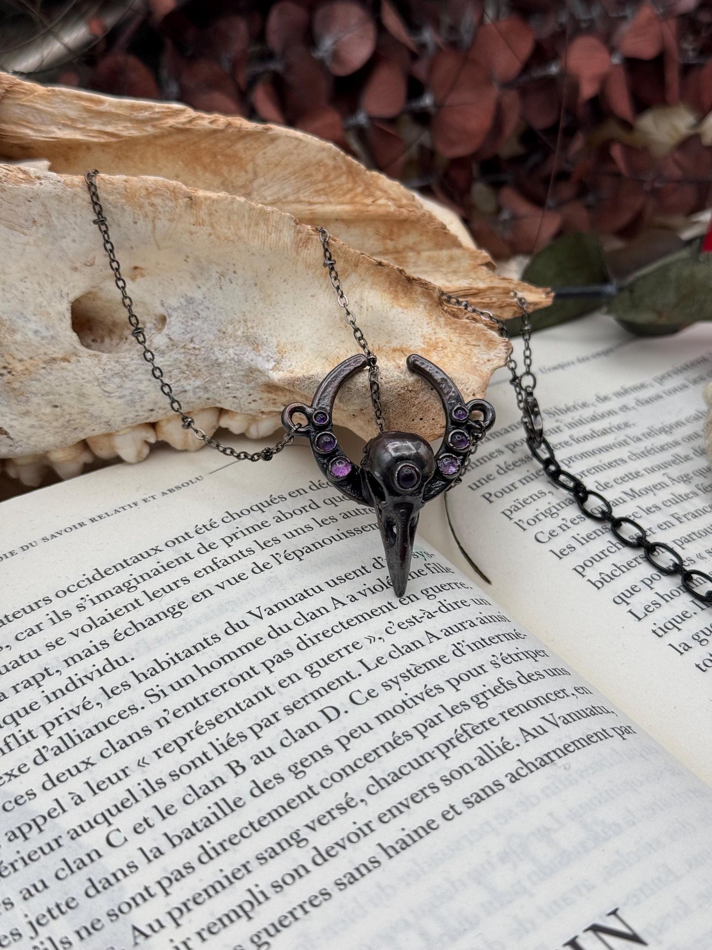 Goth Copper eformed 3d printed raven skull gunblack finish with amethysts on a moon frame, resin vegan skull on a short chain