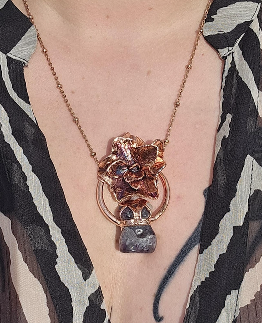 Carved amethyst with a real hydrangea flower eformed in copper