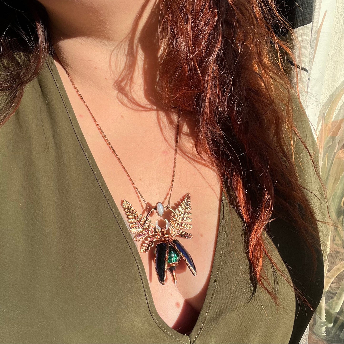 Chimera vial necklace with glittery green water, Copper eformed real beetle elytras with ferns wings, a rainbow moonstone and a white moon