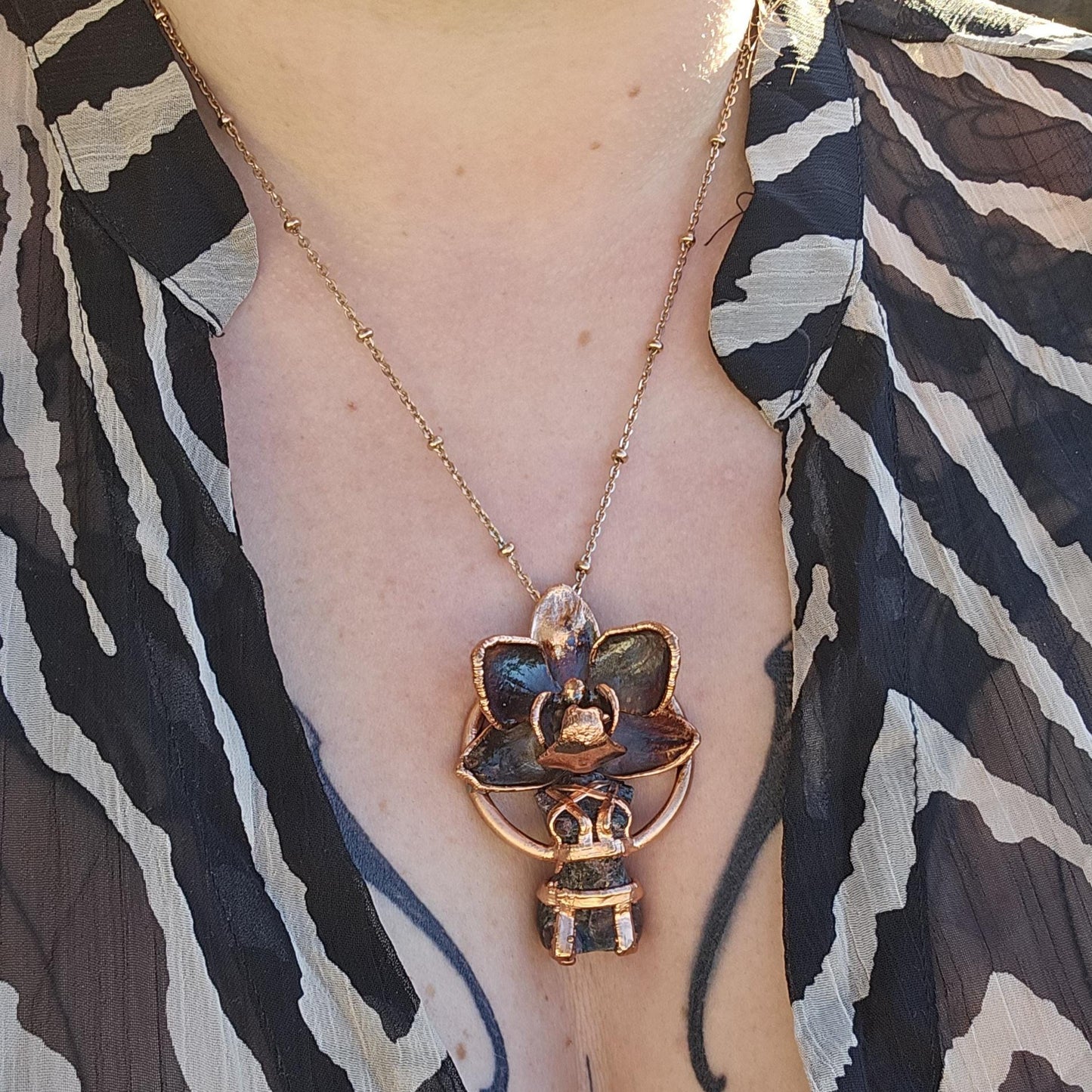 Carved garnet with a real orchid eformed in copper , naughty fairy, delicate necklace on medium chain