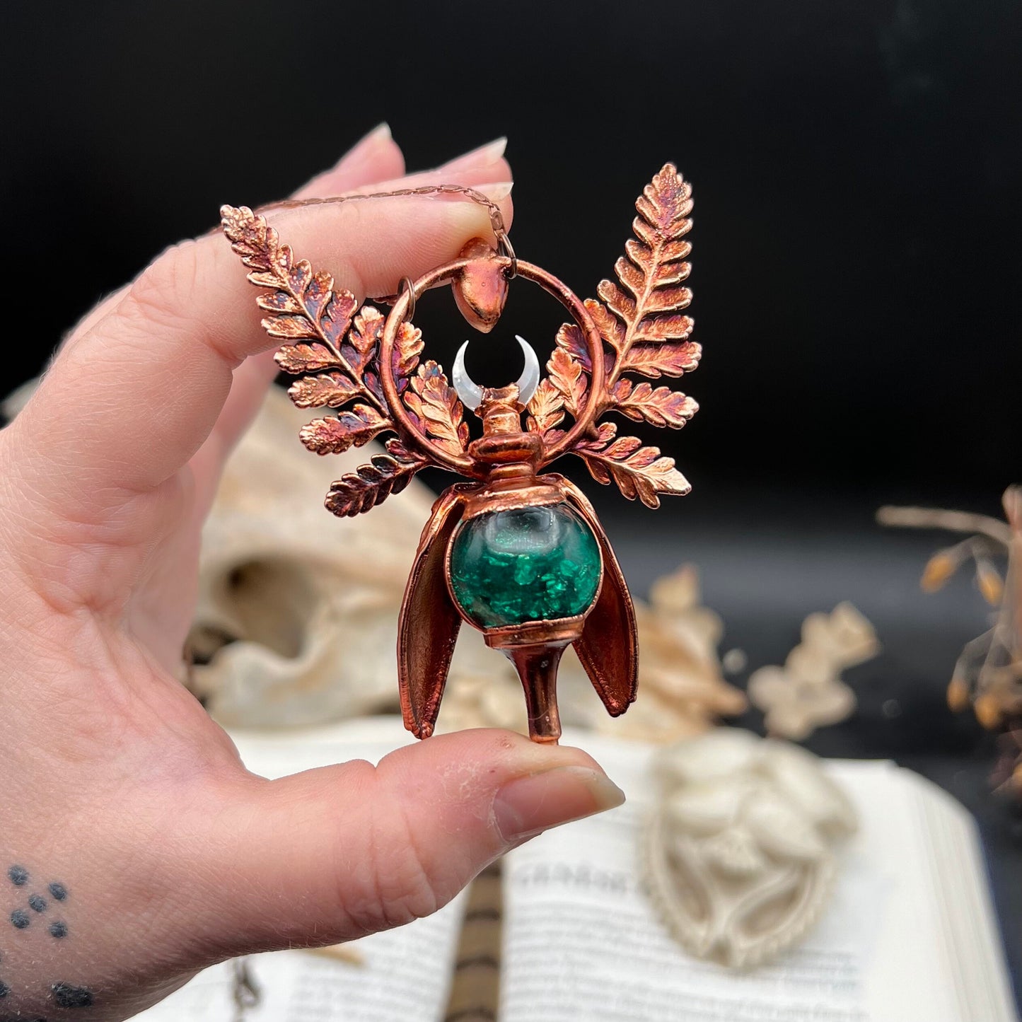 Chimera vial necklace with glittery green water, Copper eformed real beetle elytras with ferns wings, a rainbow moonstone and a white moon