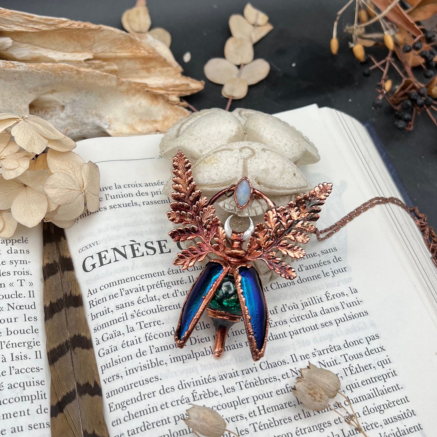 Chimera vial necklace with glittery green water, Copper eformed real beetle elytras with ferns wings, a rainbow moonstone and a white moon