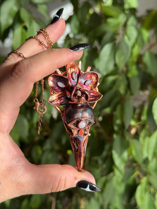 Copper eformed resin raven skull with a real orchid