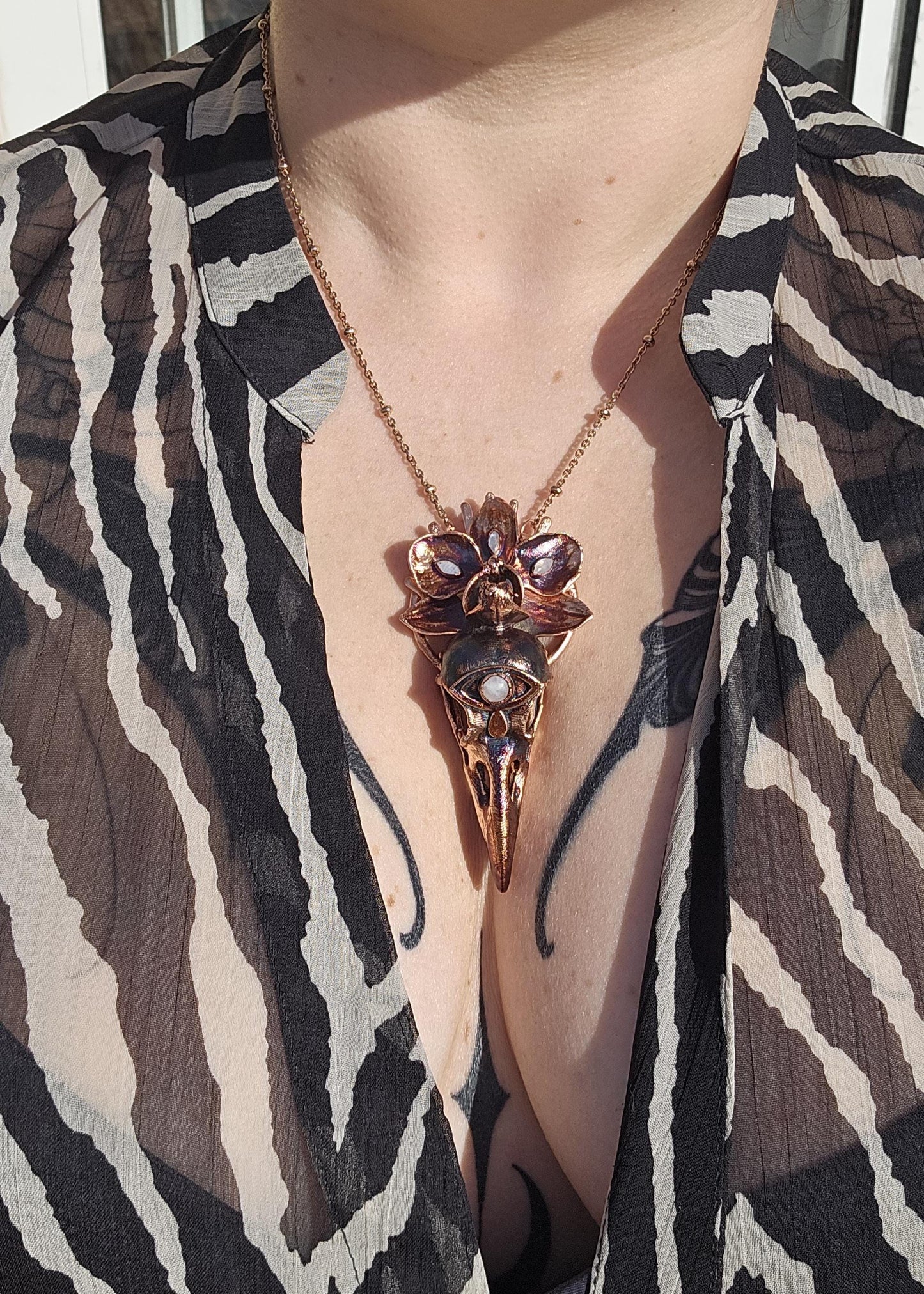 Copper eformed resin raven skull with a real orchid