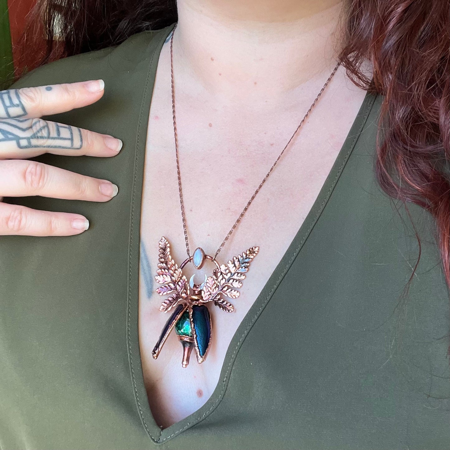 Chimera vial necklace with glittery green water, Copper eformed real beetle elytras with ferns wings, a rainbow moonstone and a white moon