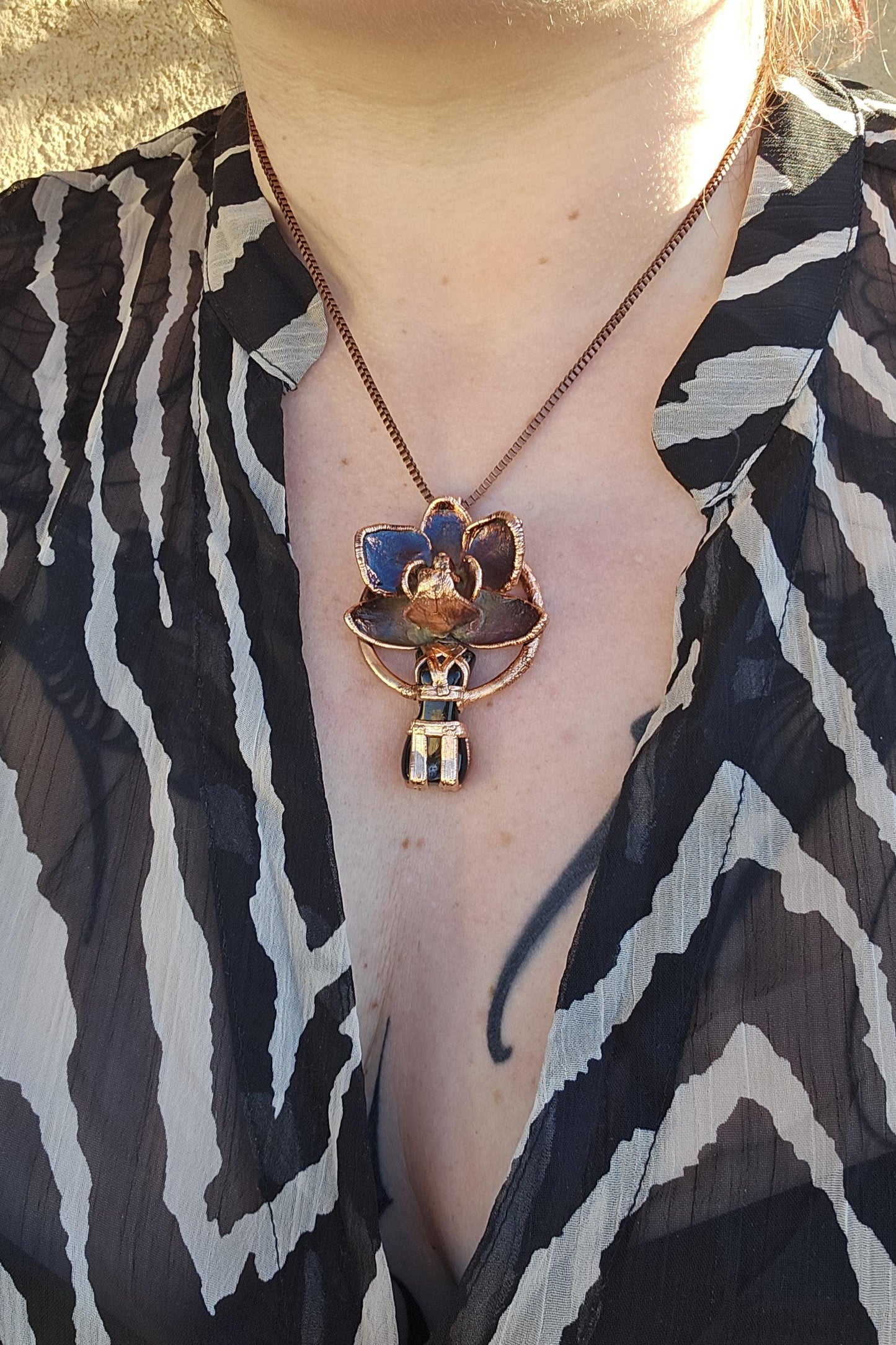 Carved obsidian with a real orchid eformed in copper ,  naughty fairy,  delicate necklace on medium chain