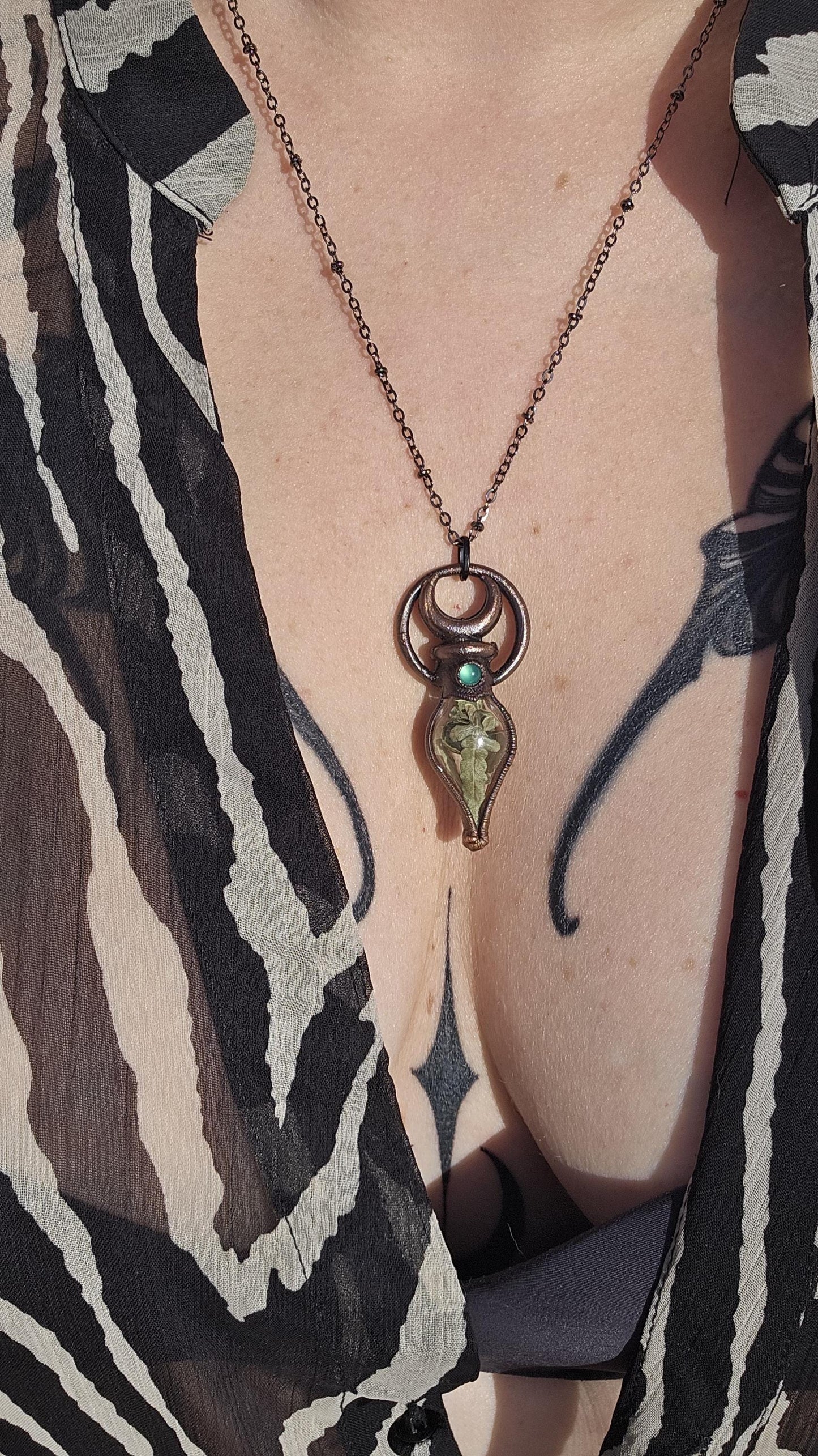 Simple vial filled with fern, Copper eformed necklace with dark finish adorned with a tiny green onix