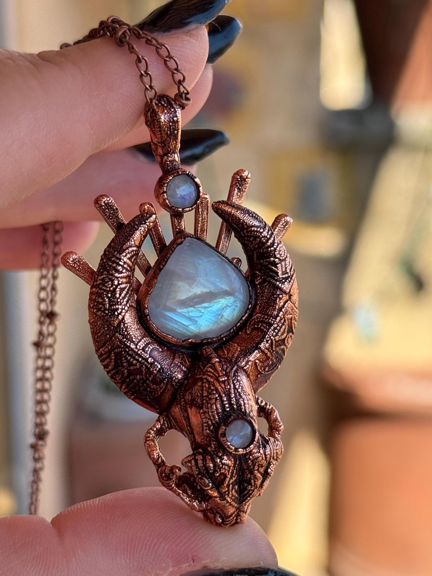 Copper eformed carved resin cat skull with Necronomicon symbols and rainbow moonstones on a satellite chain, witchy necklace