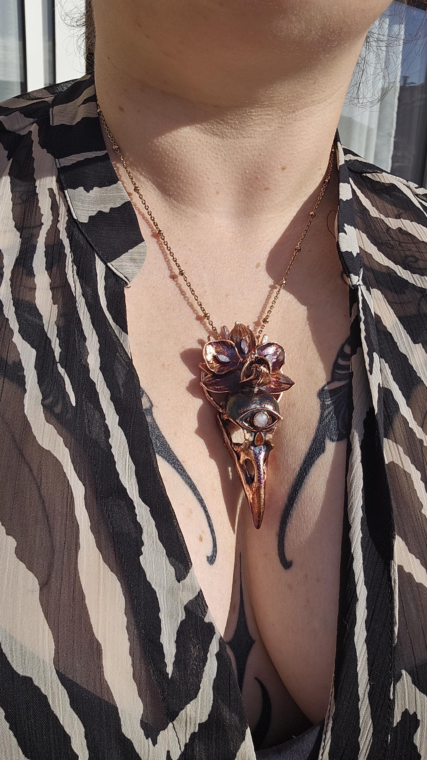 Copper eformed resin raven skull with a real orchid