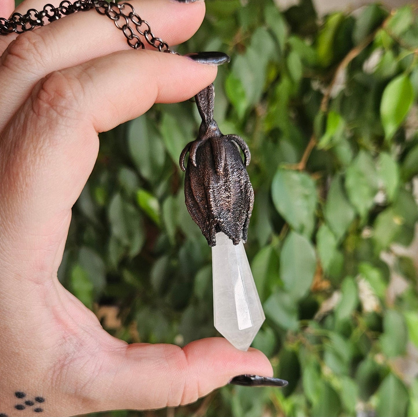 quartz point copper eformed on a real hibiscus bud, with a dark gunblack patina, medium long delicate dark fairy goth necklace