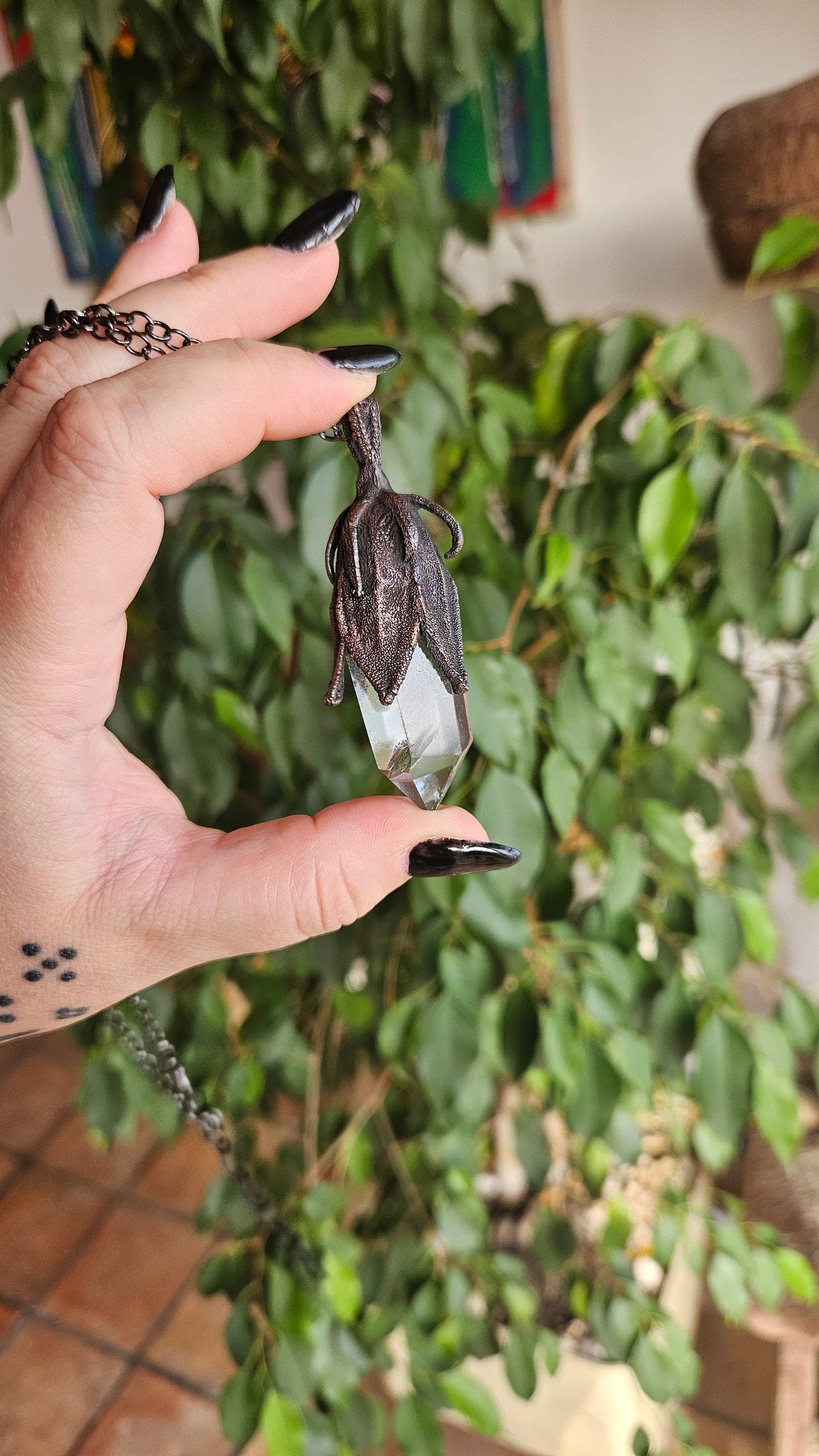 quartz point copper eformed on a real hibiscus bud, with a dark gunblack patina, medium long delicate dark fairy goth necklace