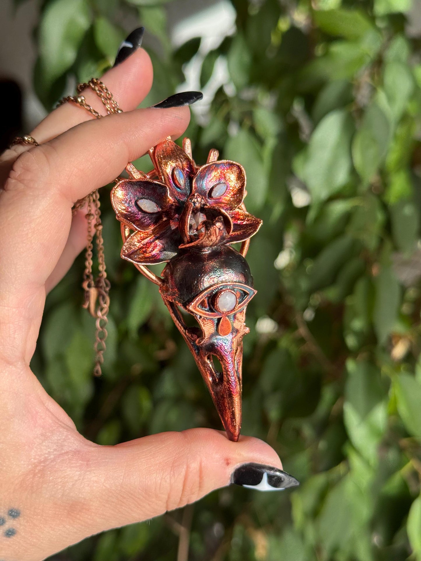 Copper eformed resin raven skull with a real orchid