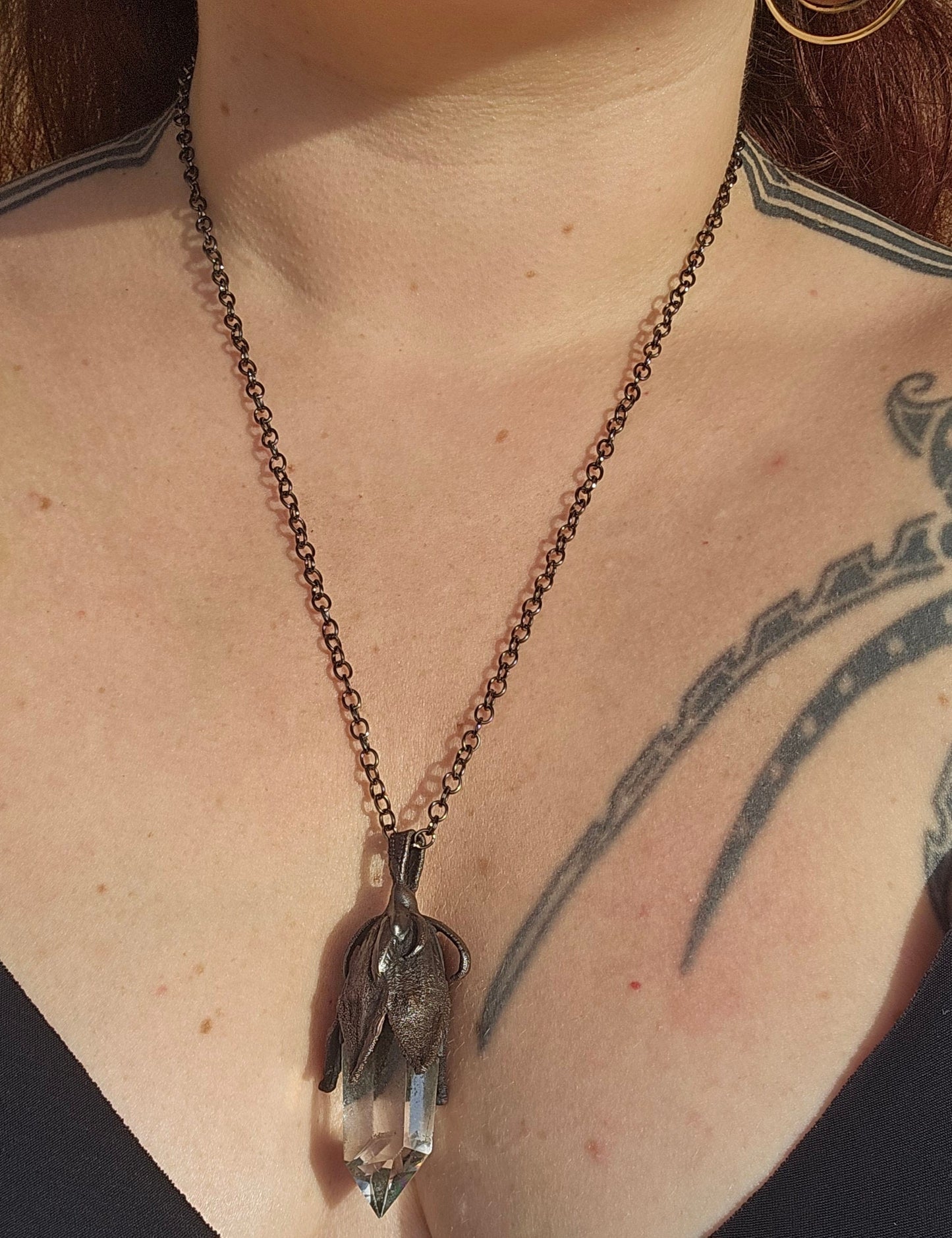 quartz point copper eformed on a real hibiscus bud, with a dark gunblack patina, medium long delicate dark fairy goth necklace