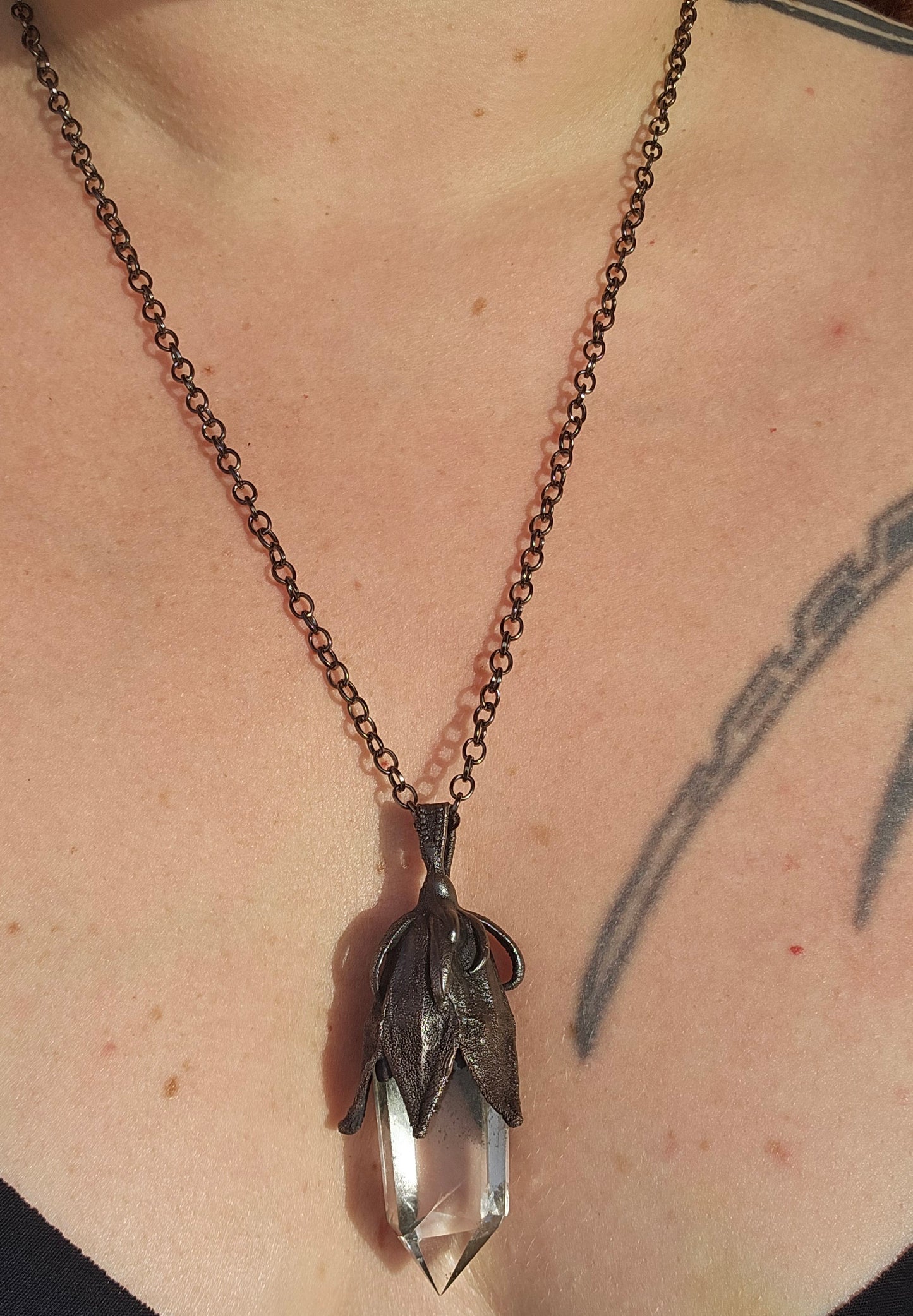 quartz point copper eformed on a real hibiscus bud, with a dark gunblack patina, medium long delicate dark fairy goth necklace