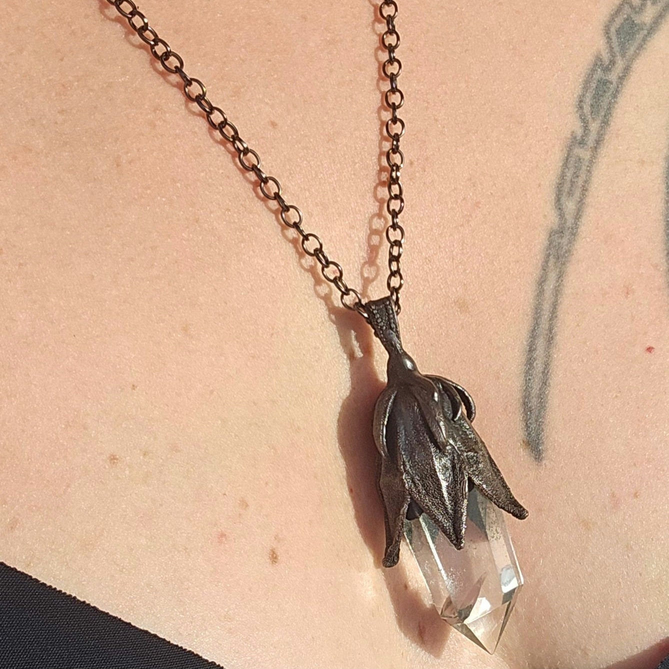 quartz point copper eformed on a real hibiscus bud, with a dark gunblack patina, medium long delicate dark fairy goth necklace