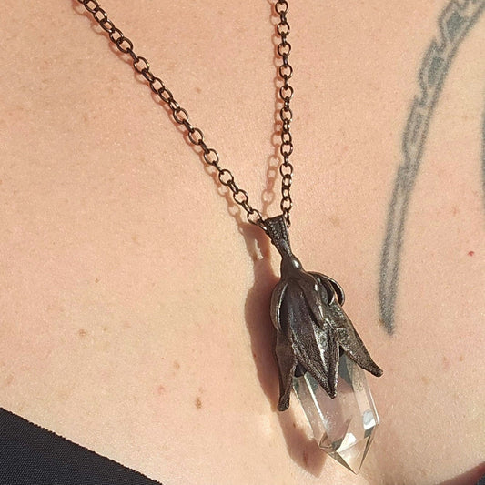 quartz point copper eformed on a real hibiscus bud, with a dark gunblack patina, medium long delicate dark fairy goth necklace