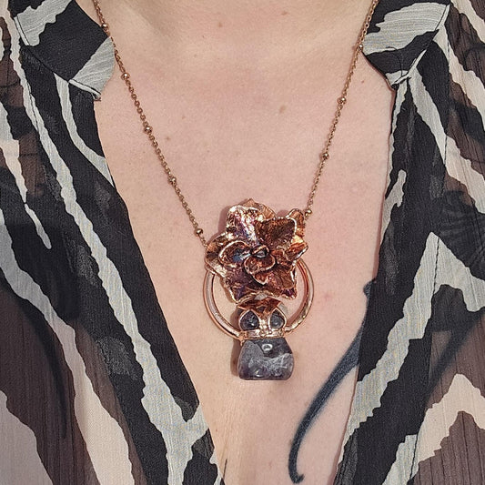 Carved amethyst with a real hydrangea flower eformed in copper